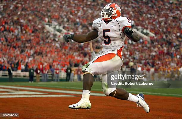 Running back Rashard Mendenhall of the Illinois Fighting Illini celebrates after scoring the Illini's first touchdown in the third quarter over the...