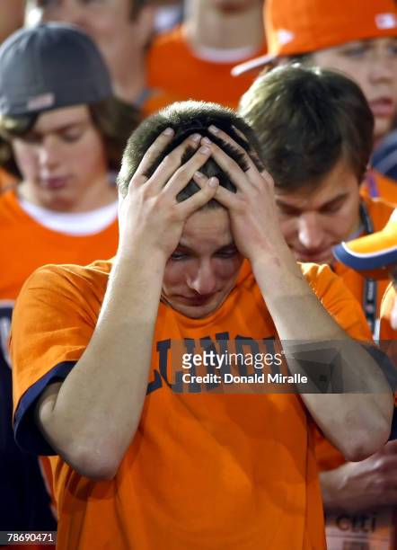 Fan of the Illinois Fighting Illini holds his head down late in the fourth quarter against the USC Trojans in the "Rose Bowl presented by Citi" at...