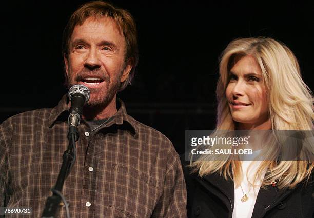 Actor Chuck Norris and his wife, Gena O'Kelley, speak during a "Huck and Chuck" rally for Republican Presidential hopeful and former Arkansas...