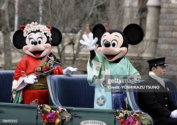 Disney characters Mickey and Minnie Mouse , dressed in Japanese traditional kimonos, wave to greet guests from a chauffer driven limousine during a...