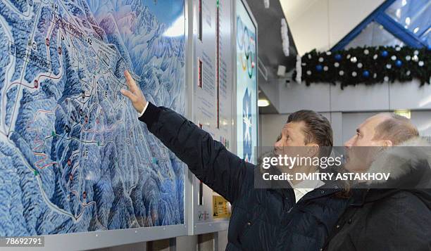 Russian President Vladimir Putin listens to Gazprom CEO Alexey Miller visiting a new ski resort "Krasnaya Polyana" outside Sichi, 02 January 2008,...