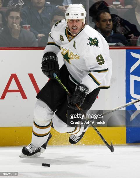 Mike Modano of the Dallas Stars carries the puck up ice during their game against the Vancouver Canucks at General Motors Place on December 20, 2007...