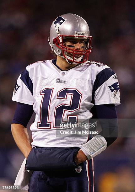 Tom Brady of the New England Patriots looks on from the field against the New York Giants on December 29, 2007 at Giants Stadium in East Rutherford,...