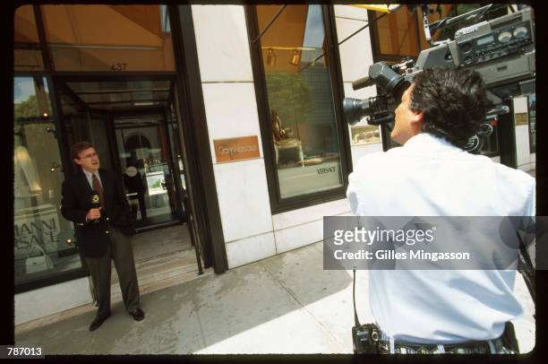 Cameraman records a television reporter standing outside of a Versace store after the murder of designer Gianni Versace July 15, 1997 in Beverly...