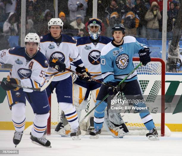 Ryan Miller, Toni Lydman, and Jochen Hecht of the Buffalo Sabres watch the puck in front of Colby Armstrong of the Pittsburgh Penguins in the NHL...