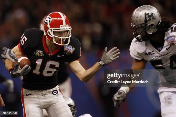 Kris Durham of the Georgia Bulldogs runs down the field against Amani Purcell of the Hawaii Warriors on January 1, 2008 during the Allstate Sugar...