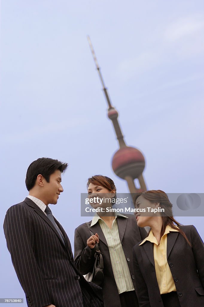 Businessman and Businesswoman Chatting in City