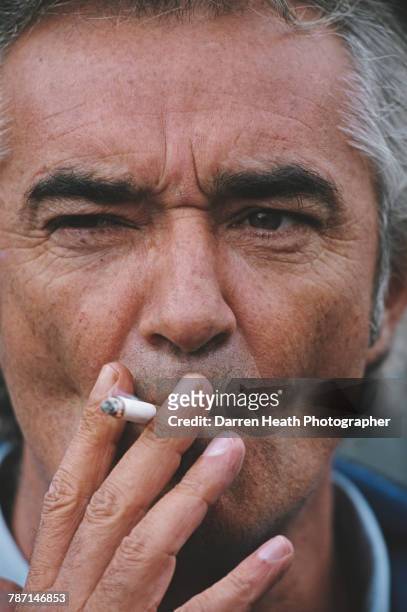 Portrait of Flavio Briatore, team principal for the Mild Seven Benetton Playlife F1 Team as he smokes a cigarette during the Formula One European...