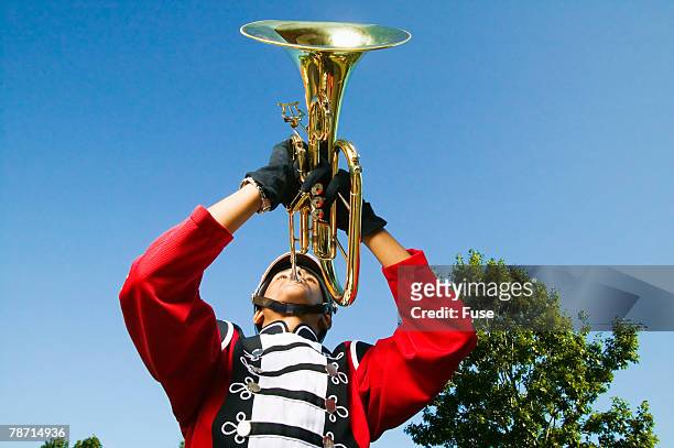 baritone horn player in marching band - blue boy band stock pictures, royalty-free photos & images