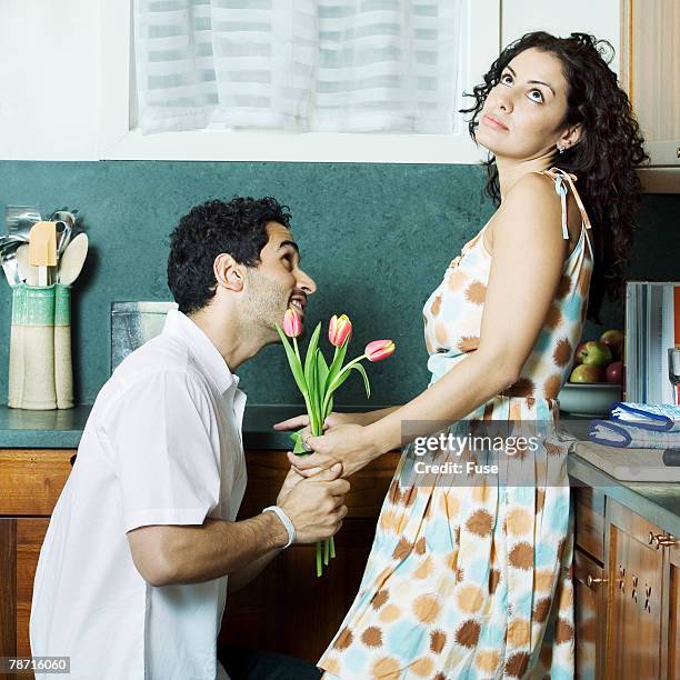 woman receiving flowers - begging animal behavior stockfoto's en -beelden