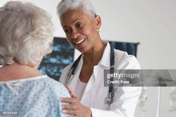 doctor speaking with patient - gerontology stock pictures, royalty-free photos & images