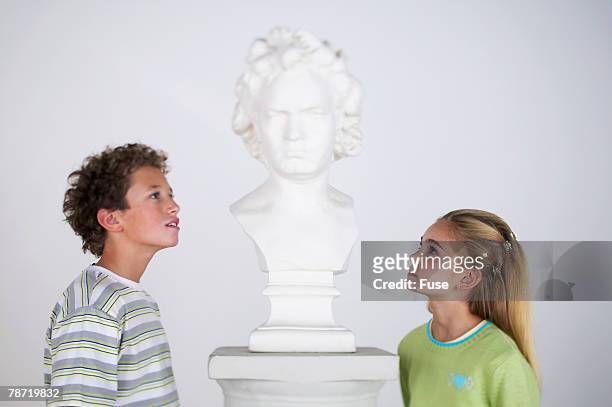 children looking at sculpture - bust museum stock-fotos und bilder