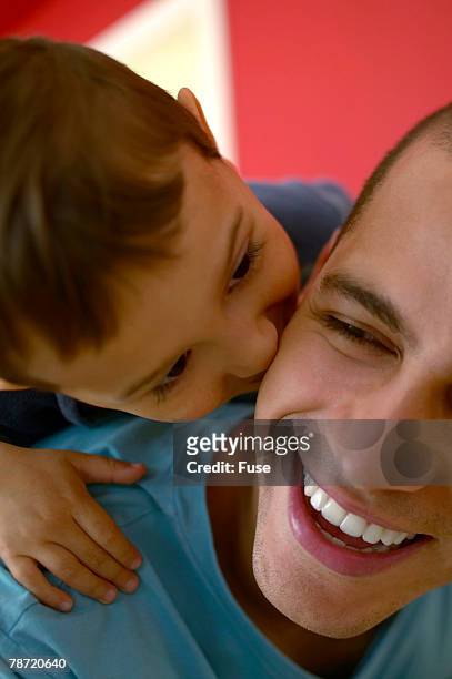 boy kissing father on cheek - extreme close up kiss stock pictures, royalty-free photos & images