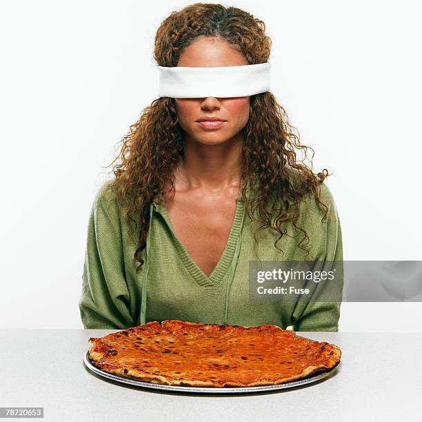 blindfolded woman with pizza - taste test stock pictures, royalty-free photos & images