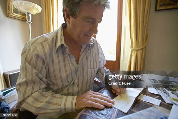 Man Write Check Senior Writing A Check Photos and Premium High Res Pictures - Getty Images