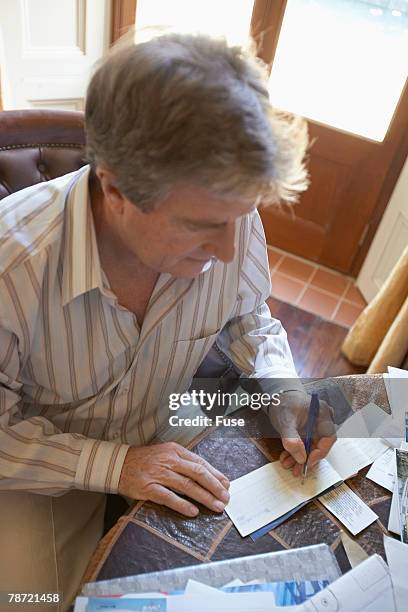 Man Write Check Senior Writing A Check Photos and Premium High Res Pictures - Getty Images