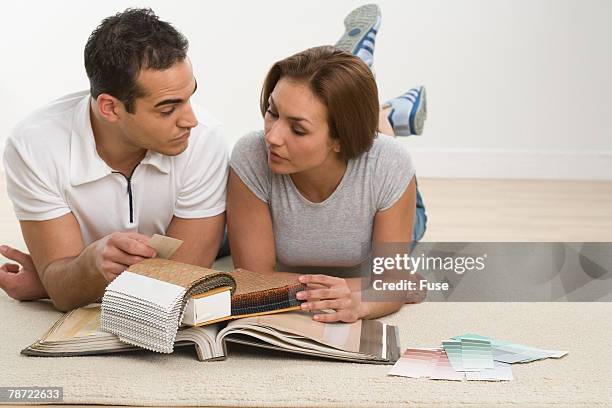 couple selecting fabric and paint swatches - renovation of upholstered furniture stock pictures, royalty-free photos & images