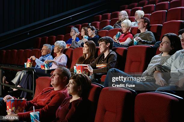 people watching movie in theater - kinosaal stock-fotos und bilder