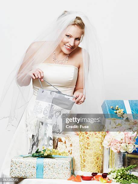 bride peeking in presents - naughty bride stock pictures, royalty-free photos & images