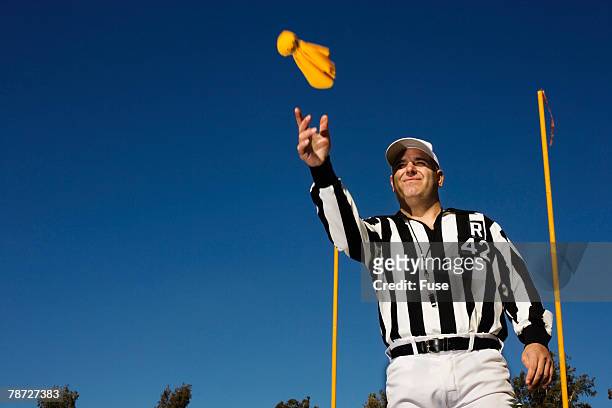 referee tossing penalty flag - football schiedsrichter stock-fotos und bilder