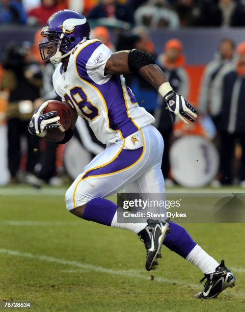 Adrian Peterson of the Minnesota Vikings heads upfield as he returns a kickoff during the football game against the Denver Broncos at Invesco Field...