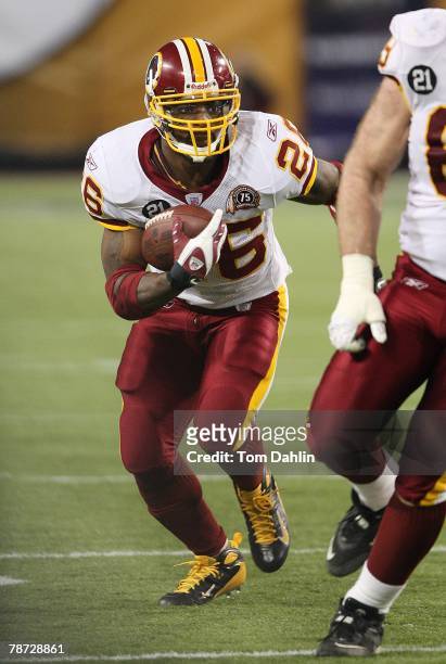 Clinton Portis of the Washington Redskins carries the ball during an NFL game against the Minnesota Vikings at the Hubert H. Humphrey Metrodome,...