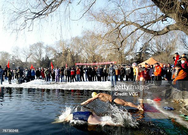 Swimmers compete in a winter swimming event in a chilly river on January 1, 2008 in Shenyang, Northeast China's Liaoning Province. More than 200...