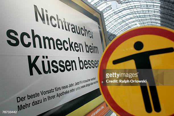 Sign that reads 'Nichtraucher schmecken beim Kuessen besser' 'kissing a non smoker tastes better' is pictured at the main train station January 3,...