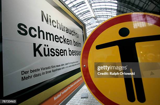 Sign that reads 'Nichtraucher schmecken beim Kuessen besser' 'kissing a non smoker tastes better' is pictured at the main train station January 3,...