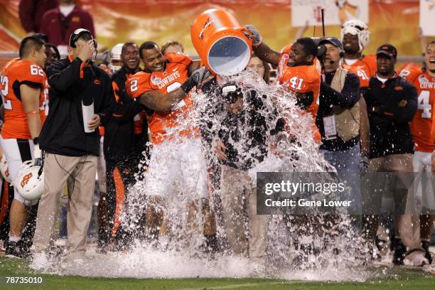 Head coach Mike Gundy of Oklahoma State gets a Gator Aid bath at the end of the game against Indiana University in the Insight Bowl on December 31,...