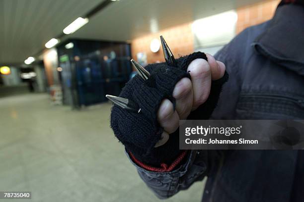 Young man shows his knuckle duster at the basement of Kieferngarten Underground Station on January 3, 2007 in Munich, Germany. After an elder man was...