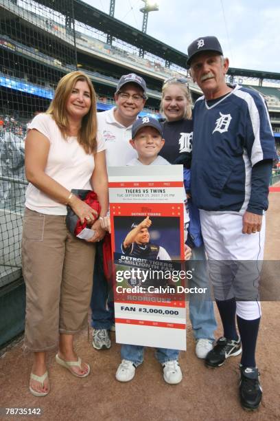 Charlie Woody, Detroit Tigers three millionth fan of the season, and his family pose with commemorative ticket and Tigers manager Jim Leyland before...