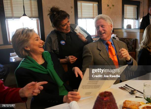 Democratic presidential candidate Sen. Hillary Clinton and her husband former U.S. President Bill Clinton laugh with waitress, Dawny Valdez, as they...