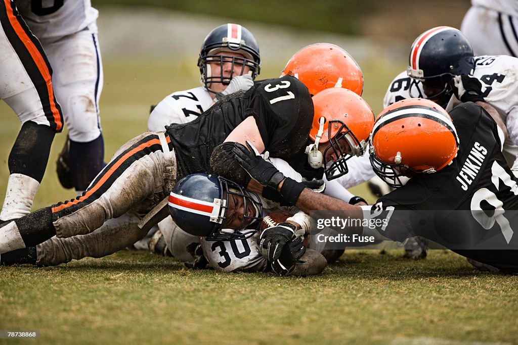 Football Player Getting Tackled