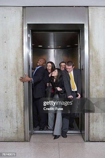 businesspeople in crowded elevator - crowded elevator stockfoto's en -beelden