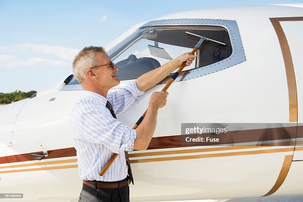 Businessman Cleaning Airplane Canopy