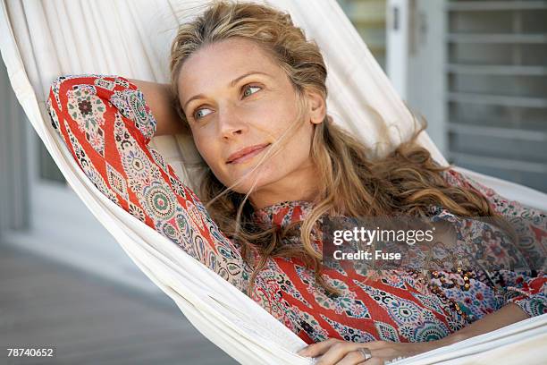 pretty woman relaxing in hammock - paisley pattern stock pictures, royalty-free photos & images