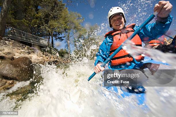 whitewater rafter blasting through rapid - whitewater rafting stock-fotos und bilder