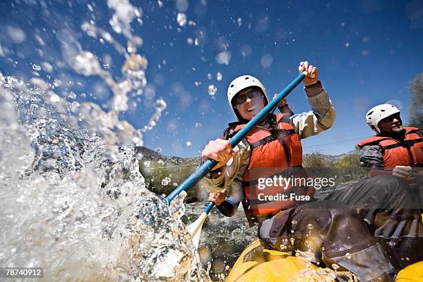 whitewater rafters splashing water - rafting stock-fotos und bilder