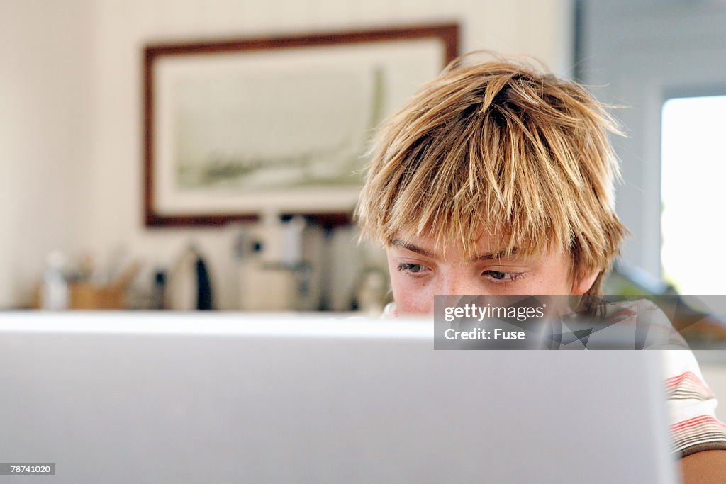 Teenage Boy Using Laptop