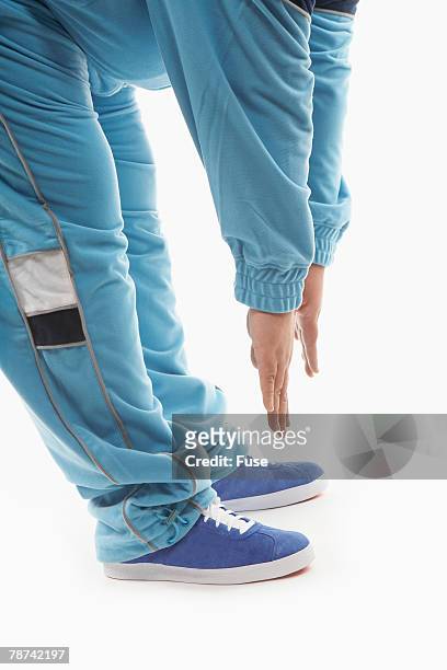 man attempting to touch his toes - zehenspitzen berühren stock-fotos und bilder