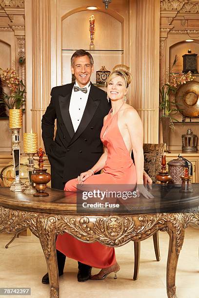 wealthy couple at luxurious desk - dinner jacket stock pictures, royalty-free photos & images