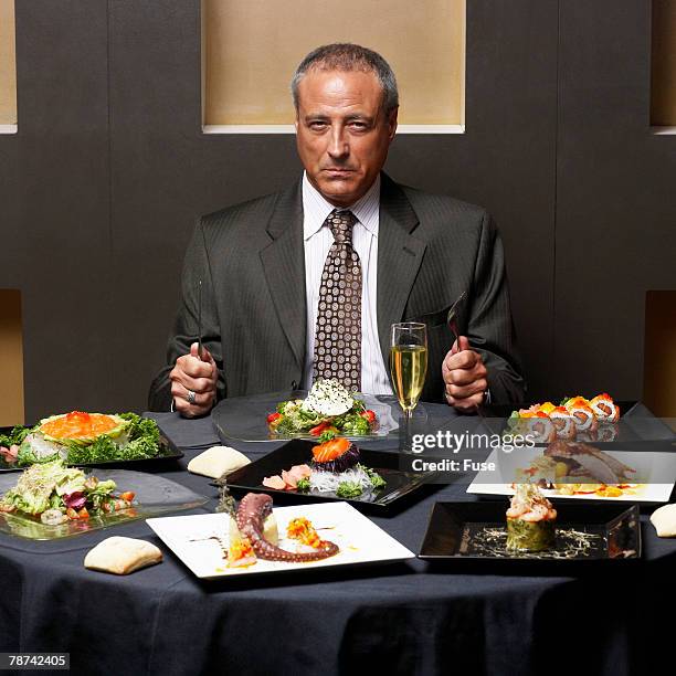 businessman having dinner - greed stock pictures, royalty-free photos & images