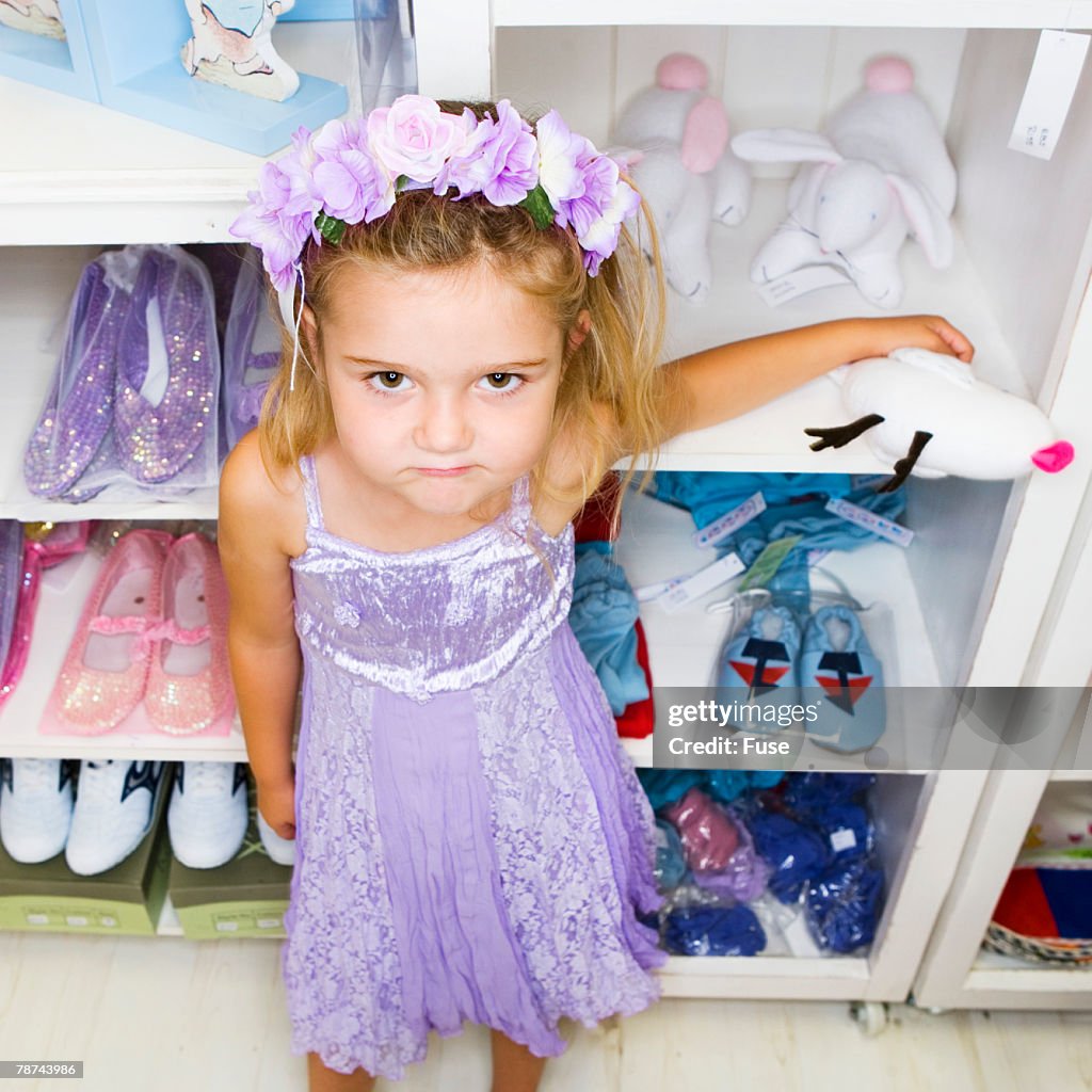 Dressed up Girl Standing at Shelf