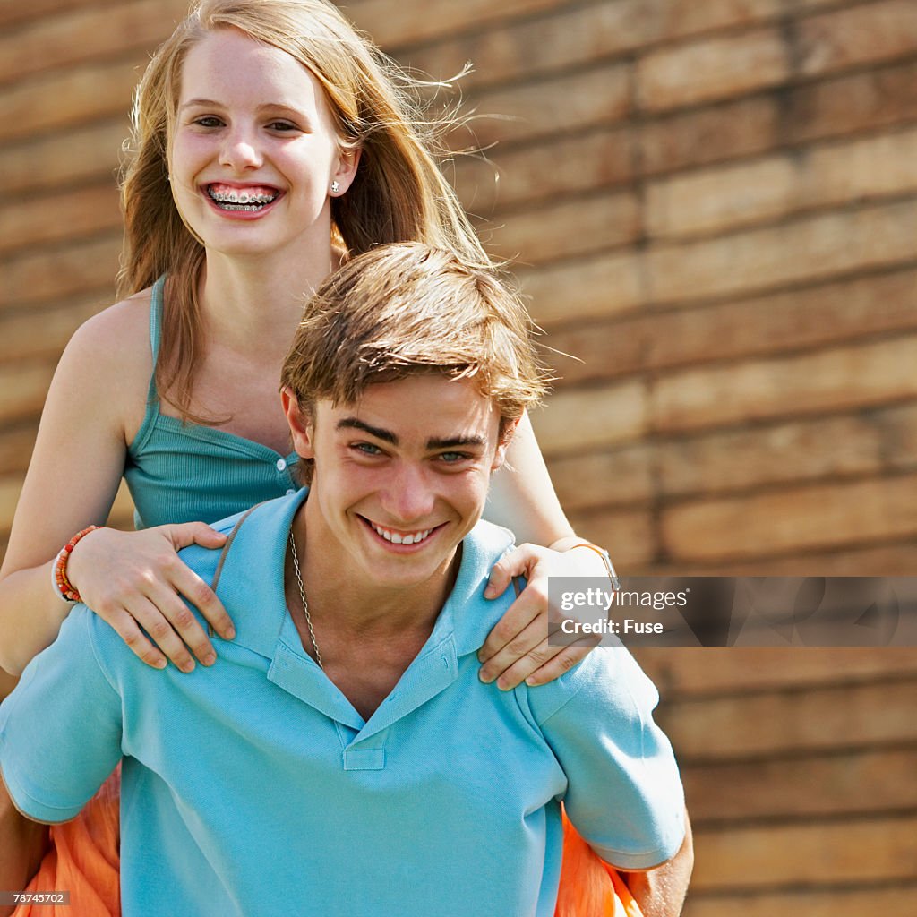 Teenage Boy Carrying Girl Piggyback