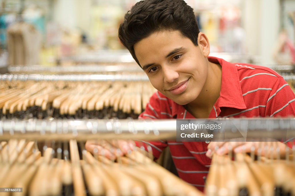 Man Browsing Racks Teenage Boy Browsing A Clothing Rack High-Res Stock Photo - Getty Images