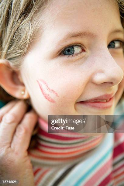 little girl receiving kisses - extreme close up kiss stock pictures, royalty-free photos & images