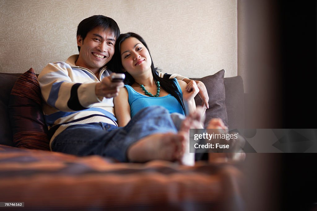 Couple Watching TV in Bed