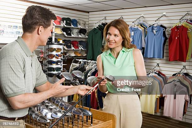 woman in a golf shop - golf merchandise stock pictures, royalty-free photos & images