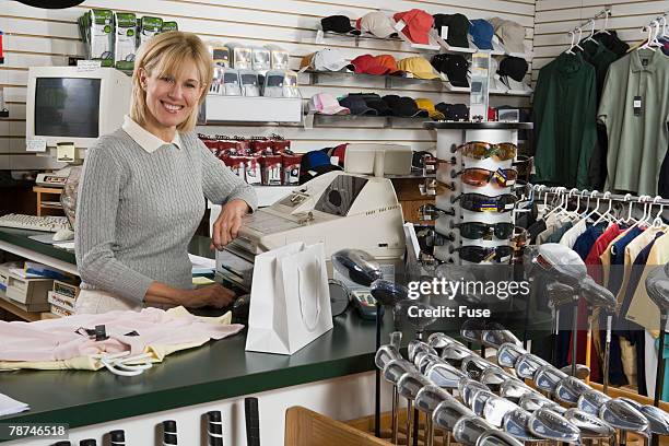 store clerk in a golf shop - golf merchandise stock pictures, royalty-free photos & images